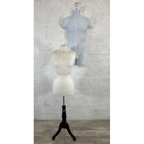 55 - Two mannequins, one plastic hanging male torso and one polystyrene female torso on tripod stand