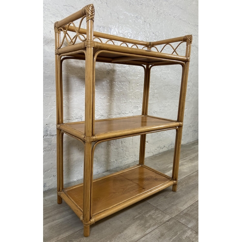 63 - A cane and wicker three tier bookshelf - approx. 90cm high x 66cm wide x 32cm deep