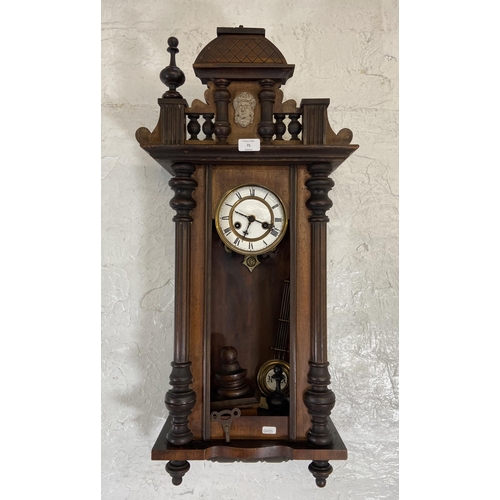 71 - A Victorian mahogany cased Vienna wall clock with pendulum and key