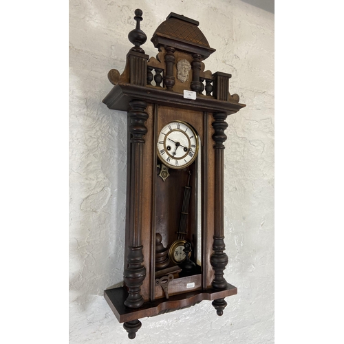 71 - A Victorian mahogany cased Vienna wall clock with pendulum and key