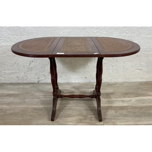 74 - Three pieces of reproduction mahogany and leather furniture, one drop leaf side table, one nest of t... 