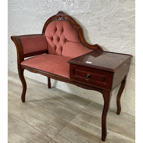 79 - A 19th century style mahogany and pink fabric upholstered telephone table