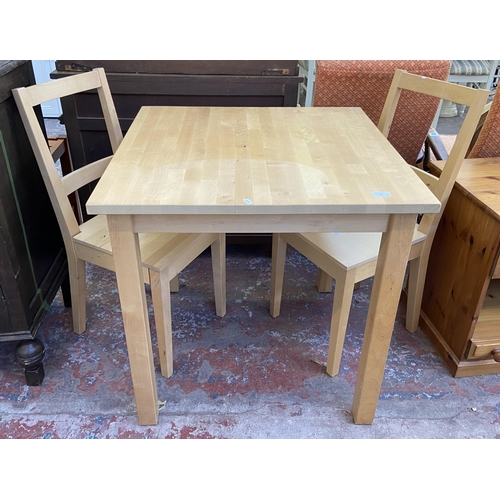 91 - An IKEA Bertil beech square dining table and two chairs