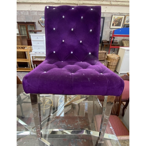 93 - A modern glass top and chrome plated dining table and two purple fabric upholstered and chrome plate... 