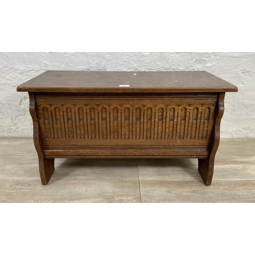 94 - A 17th century style carved oak blanket box - approx. 43cm high x 80cm wide x 34cm deep