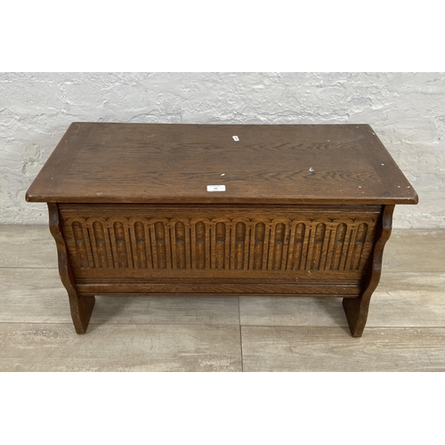 94 - A 17th century style carved oak blanket box - approx. 43cm high x 80cm wide x 34cm deep