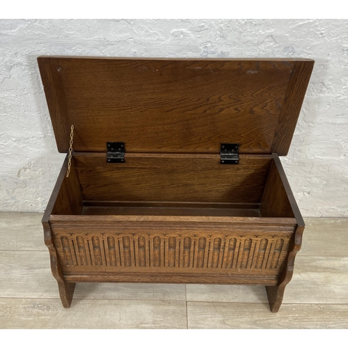 94 - A 17th century style carved oak blanket box - approx. 43cm high x 80cm wide x 34cm deep