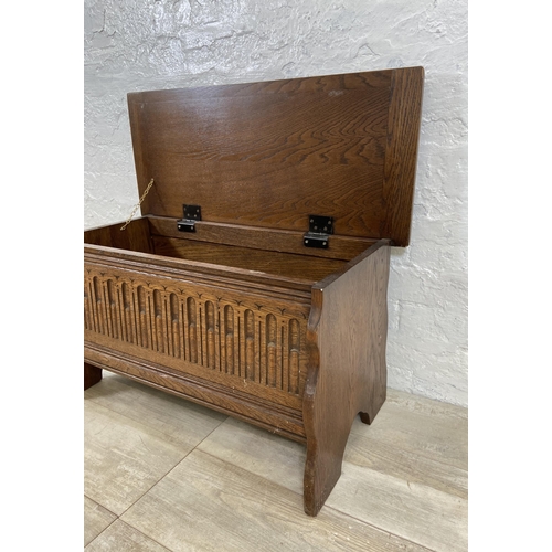 94 - A 17th century style carved oak blanket box - approx. 43cm high x 80cm wide x 34cm deep