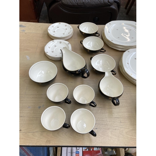 1141 - A collection of Alfred Meakin Midnight Star dinnerware to include four tea cups, two tureens, two me... 