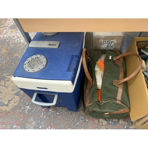 1130 - A large quantity of house clearance items to include books, Halfords cool box, ceramics, glassware e... 