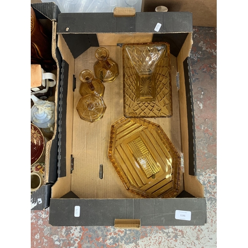 1146 - Three boxes containing amber glassware, BT landline phones, Roberts DAB radio etc.