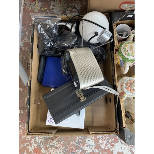 1146 - Three boxes containing amber glassware, BT landline phones, Roberts DAB radio etc.