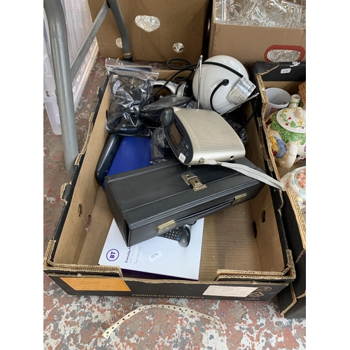 1146 - Three boxes containing amber glassware, BT landline phones, Roberts DAB radio etc.