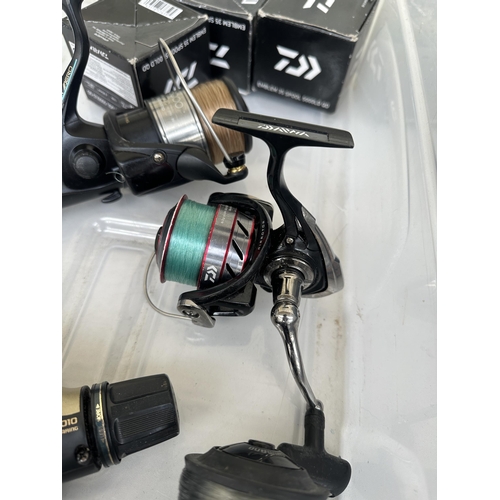 1002 - A box containing fishing reels and spools to include Shimano Baitrunner 8000, Shimano Baitrunner 600... 