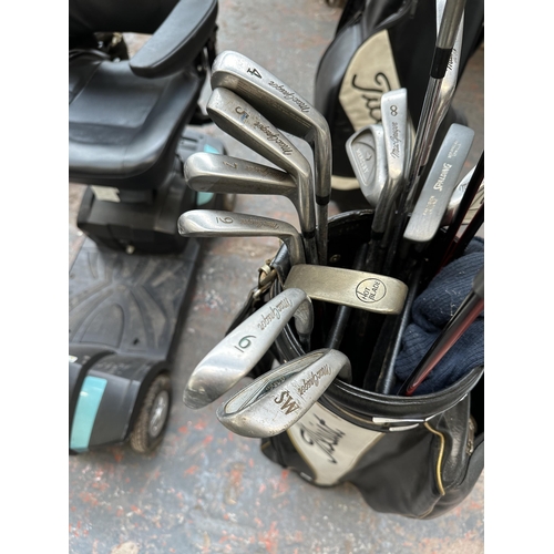 1028 - A Titleist golf bag containing left handed golf clubs to include Hippo, Slazenger etc.