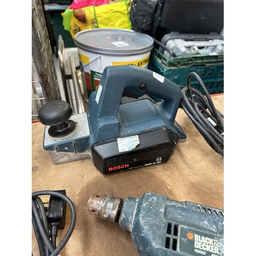 1045 - A collection of power tools to include, Bosch GH0 31-82 plane, Draper tri-base sander, Performance P... 