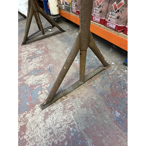 1053 - Two adjustable metal work trestles