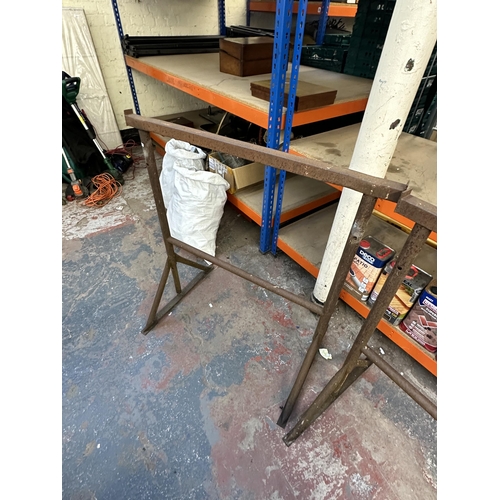 1053 - Two adjustable metal work trestles