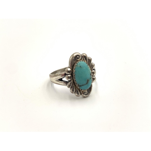 2138 - Two pieces of jewellery, one sterling silver turquoise set dress ring and one Egyptian Revival white... 