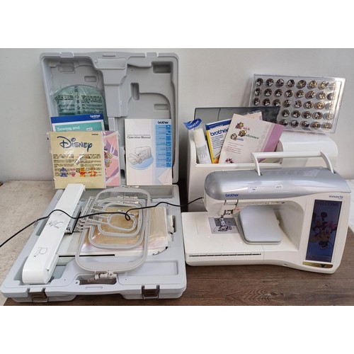 A cased Brother Innov-is 4000D Disney Edition computerised sewing and embroidery machine with foot pedal, power cable, literature and cased accessories to include forty sealed 100% polyester coloured threads etc.