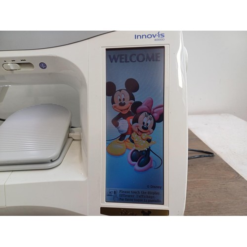 786 - A cased Brother Innov-is 4000D Disney Edition computerised sewing and embroidery machine with foot p... 