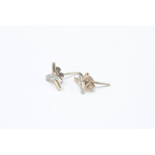 2033 - A pair of 9ct gold diamond stud earrings - approx. gross weight 0.6g