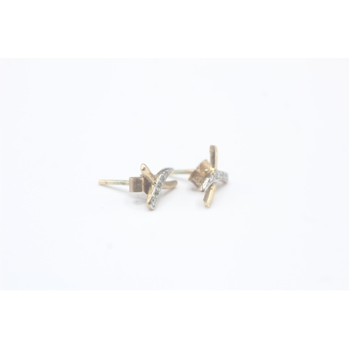 2033 - A pair of 9ct gold diamond stud earrings - approx. gross weight 0.6g