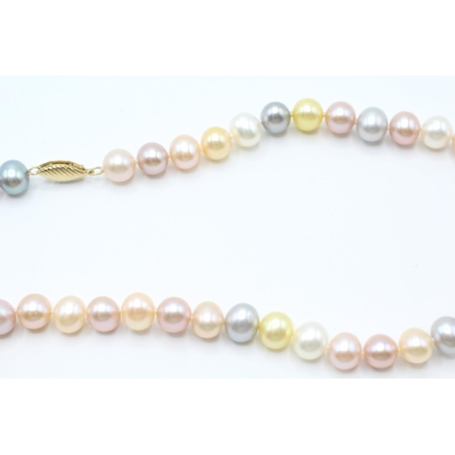 2047 - A vari-hue cultured freshwater pearl single strand necklace with 14ct gold clasp - approx. gross wei... 