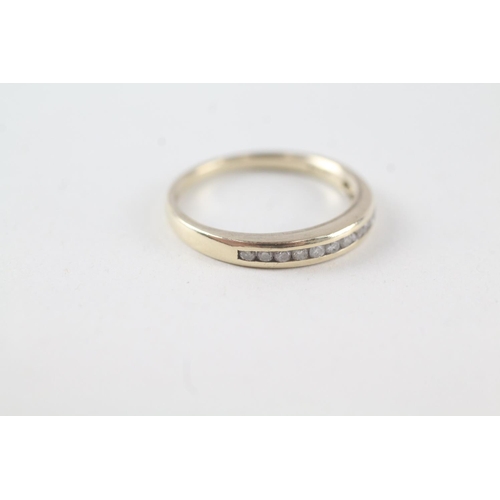 2073 - A 9ct gold channel set diamond single row band ring - approx. gross weight 1.7g