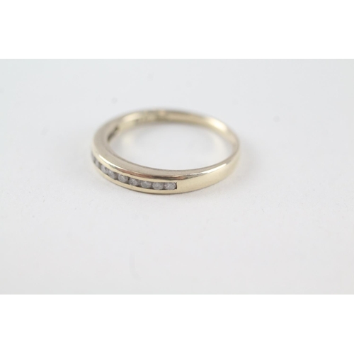 2073 - A 9ct gold channel set diamond single row band ring - approx. gross weight 1.7g