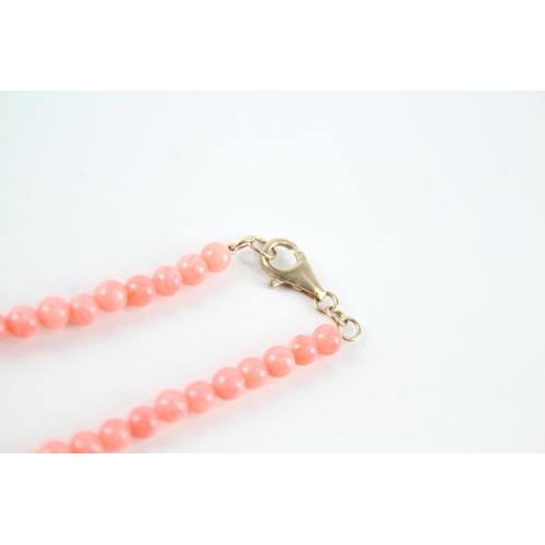 2079 - A coral single strand necklace with 9ct gold spacers and clasp - approx. gross weight 14.6g