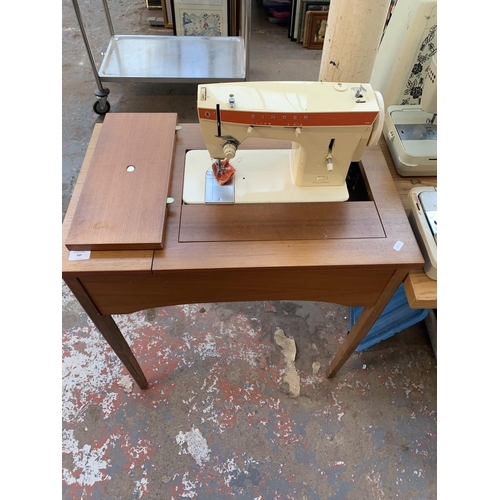 784 - A sewing machine table containing Singer 367 electric sewing machine