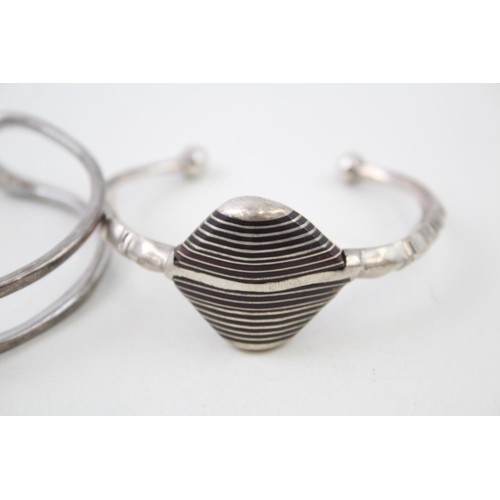 2098 - Two Modernist sterling silver bangles - approx. gross weight 68g