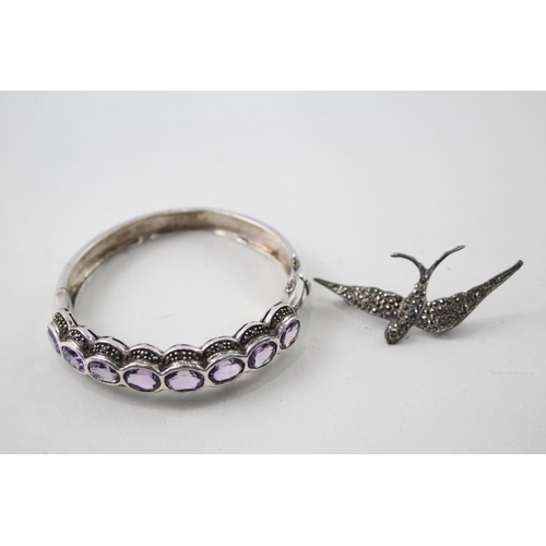 2109 - Two pieces of hallmarked sterling silver and marcasite jewellery, one amethyst set bangle and one sw... 