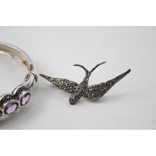 2109 - Two pieces of hallmarked sterling silver and marcasite jewellery, one amethyst set bangle and one sw... 