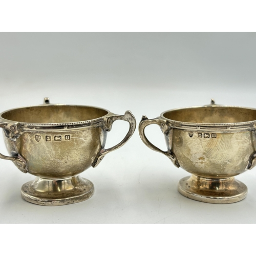 2213 - A pair of Williams (Birmingham) Ltd hallmarked Birmingham silver three handled condiment dishes, dat... 