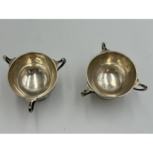 2213 - A pair of Williams (Birmingham) Ltd hallmarked Birmingham silver three handled condiment dishes, dat... 