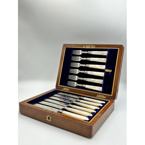 2218 - An oak cased hallmarked Sheffield silver and mother of pearl handled 12 piece cutlery set, dated 190... 