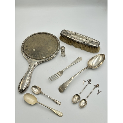 2224 - Nine hallmarked sterling silver and white metal items, two Dubai white metal souvenir spoons, three ... 