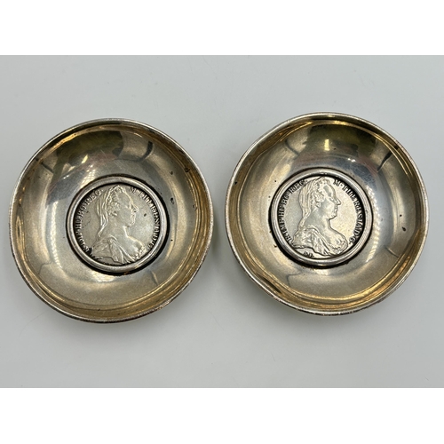 2225 - A pair of white metal circular footed dishes each set with Maria Theresa .833 silver Thaler coins - ... 