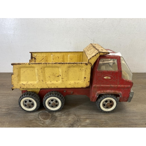 460 - Two mid 20th century tinplate toys, one clockwork tricycle and one Tonka tipper truck