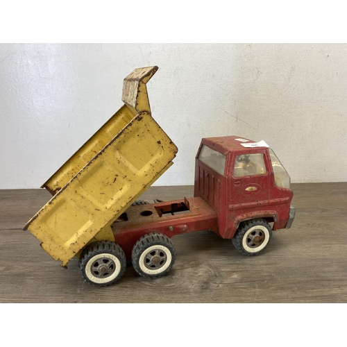 460 - Two mid 20th century tinplate toys, one clockwork tricycle and one Tonka tipper truck