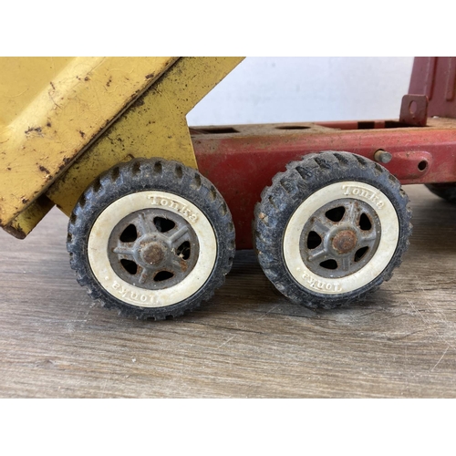 460 - Two mid 20th century tinplate toys, one clockwork tricycle and one Tonka tipper truck