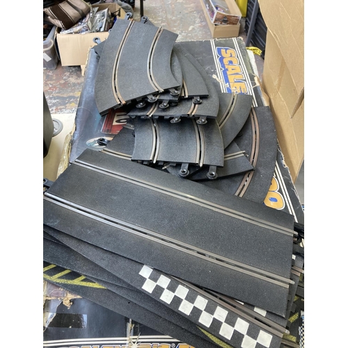 463 - A collection of slot car racing track and accessories to include Scalextric 300, Scalextric Ford RS ... 