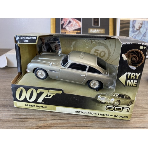 466 - A collection of James Bond 007 toys and memorabilia to include Aston Martin DB5, Lone Star The World... 