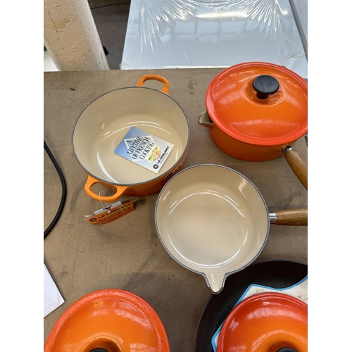 796 - Five items of Le Creuset enamelled cast iron cookware, one casserole, three graduating lidded saucep... 