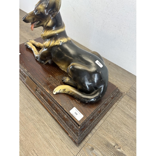 526 - A 1930s Wade ceramic Alsatian figurine on carved oak presentation plinth