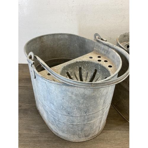 407 - Three vintage galvanized items, one rivetted bucket - approx. 33cm high x 35cm diameter and two mop ... 