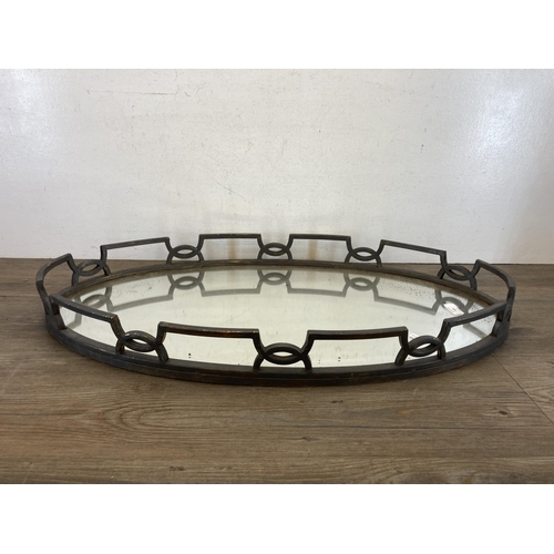 414 - A cast metal and mirrored glass serving tray - approx. 81cm long x 45cm wide