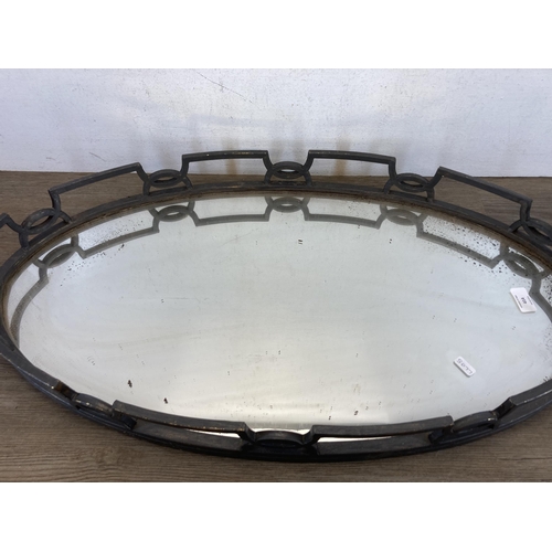 414 - A cast metal and mirrored glass serving tray - approx. 81cm long x 45cm wide